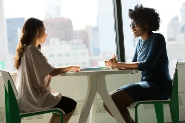 Two women in a job interview at a table